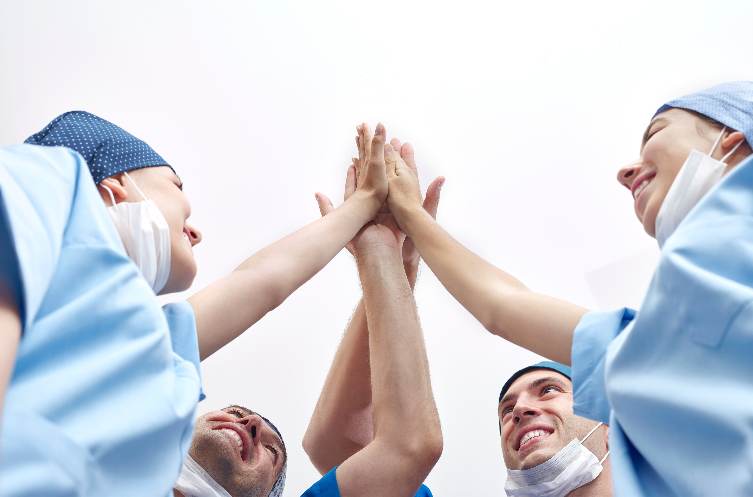 Group of doctors doing high-five